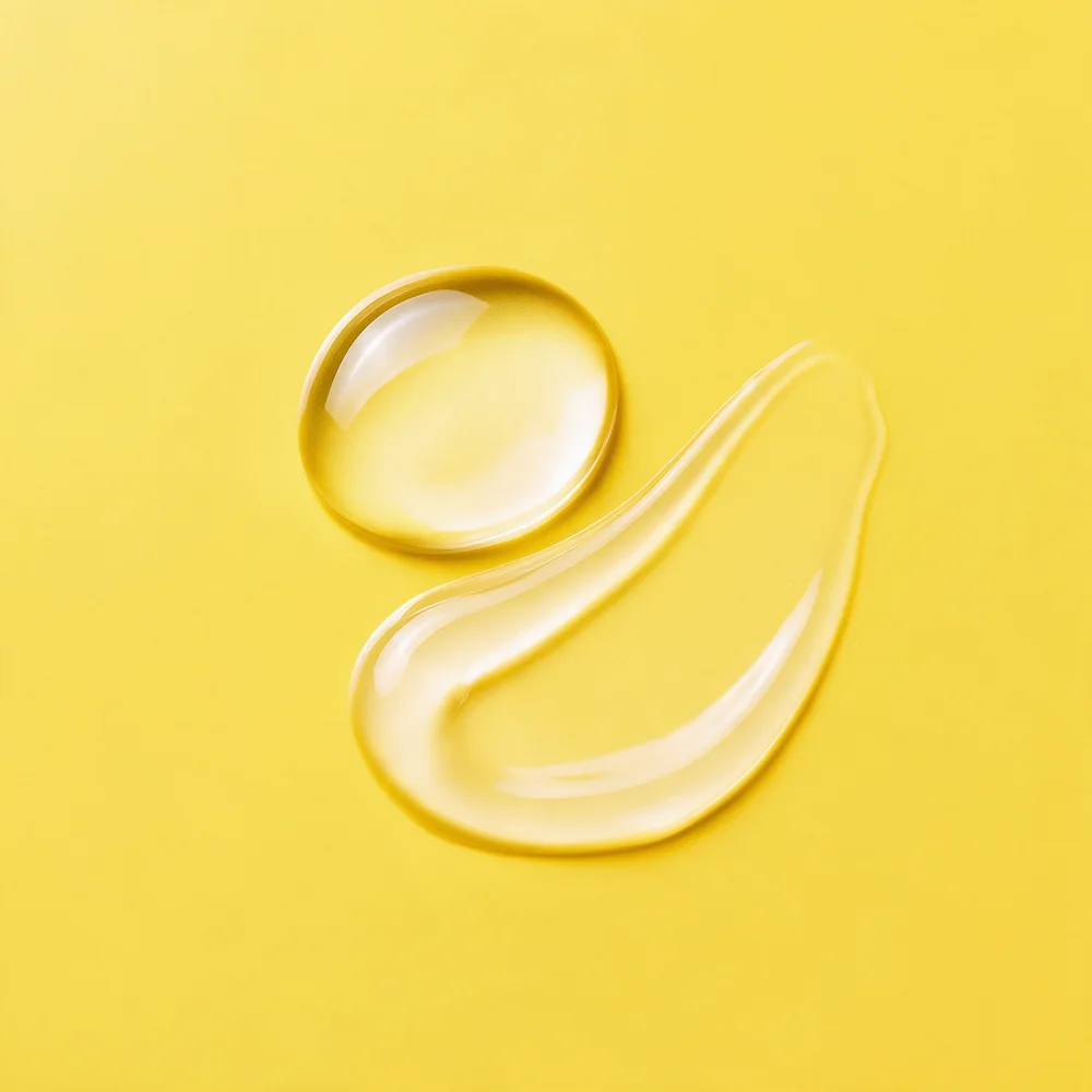 Clear serum drops on a yellow background